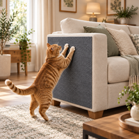 A ginger cat using the grey scratch protection mat fitted to a sofa arm