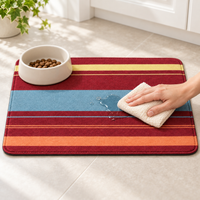 Orange striped pet feeding mat being wiped clean
